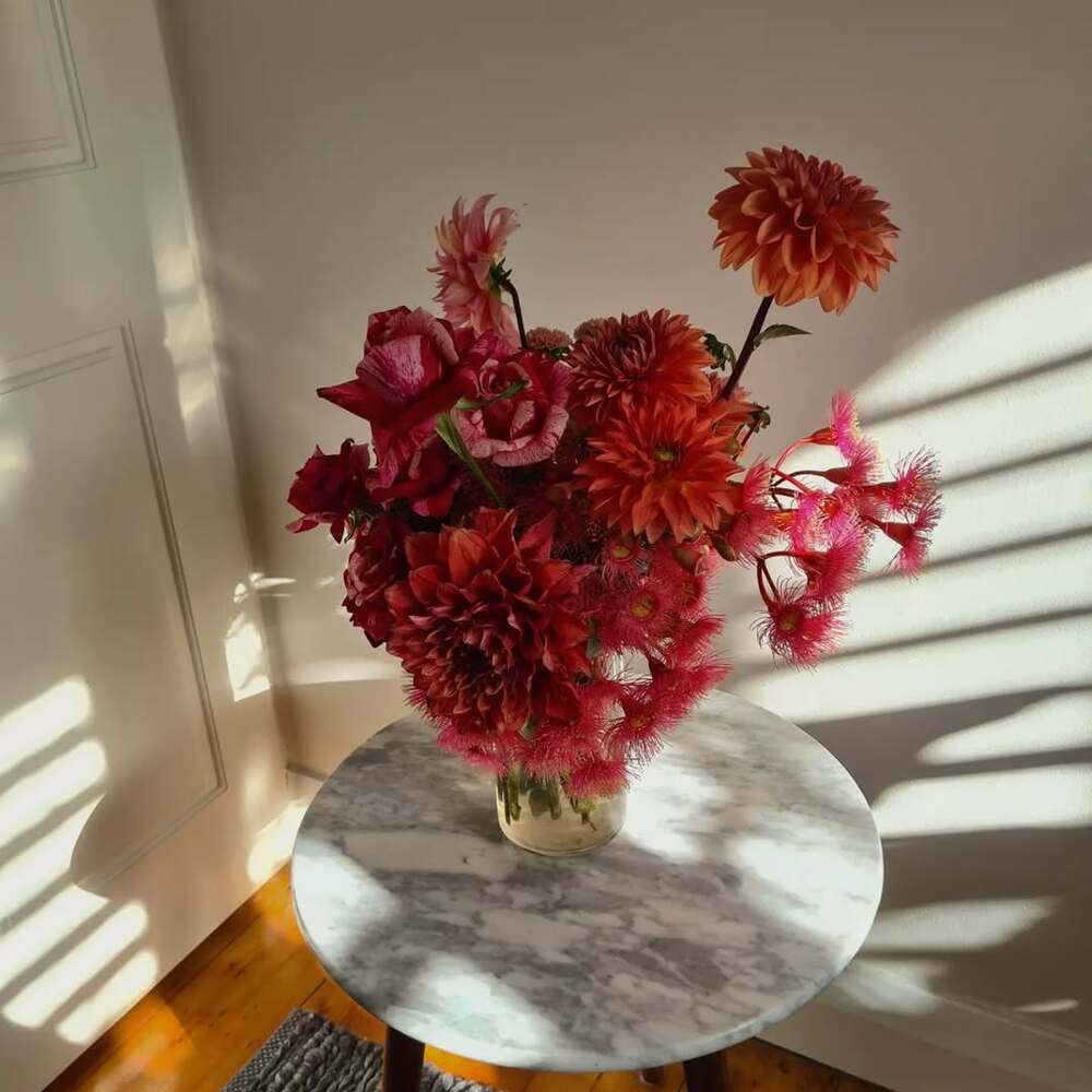 Bouquet on marble side table in sunlight Bouquet on marble side table in sunlight