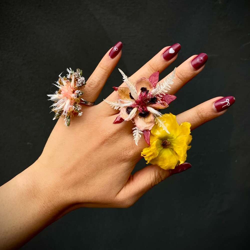 Hand with unique dry floral rings Hand with unique dry floral rings
