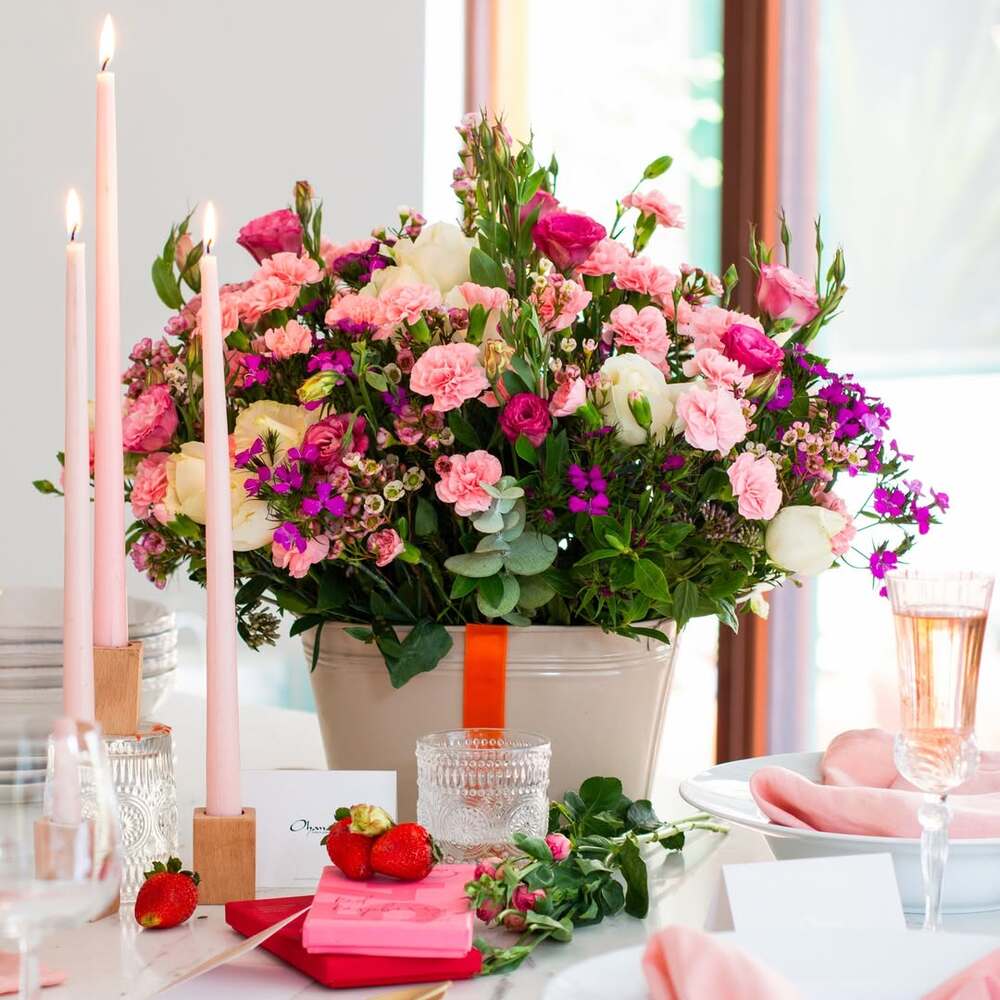 Floral centerpiece with pink table setting Floral centerpiece with pink table setting