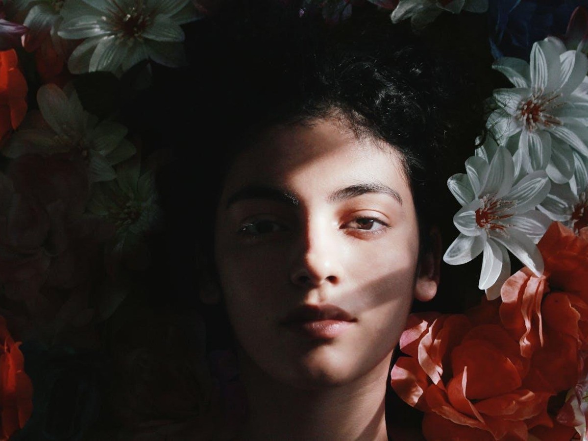 Woman framed by colorful flowers