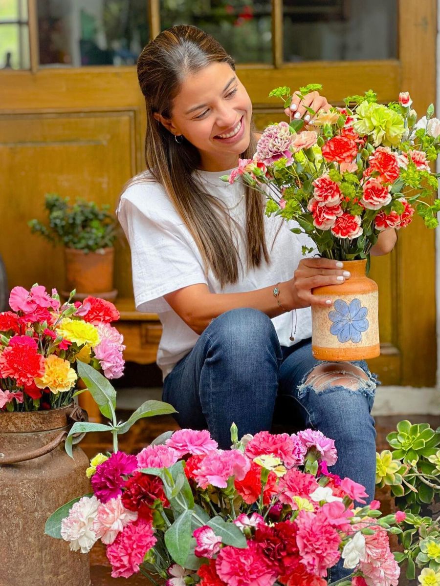 Carnations in design woman holding bunch of flowers that represent the zodiac sign Sagittarius