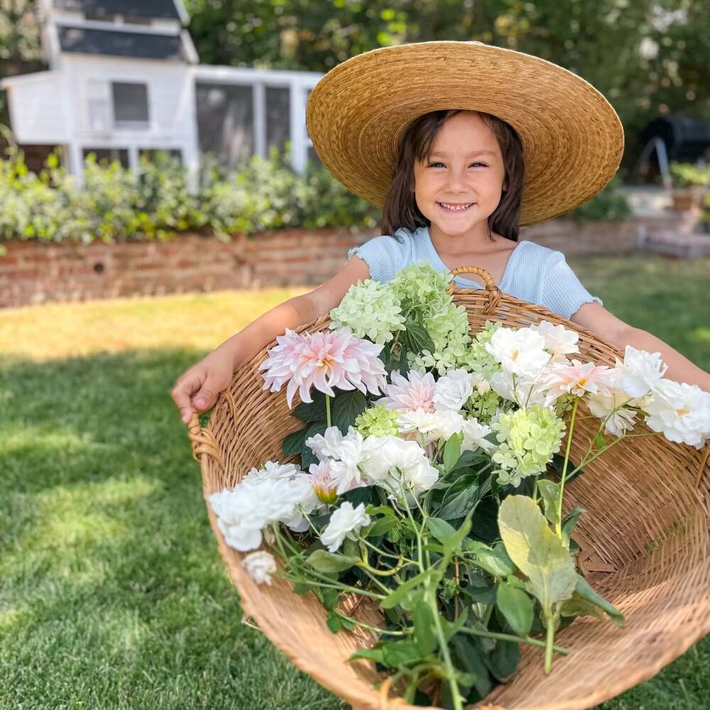 Smiling girl with flower harvest
