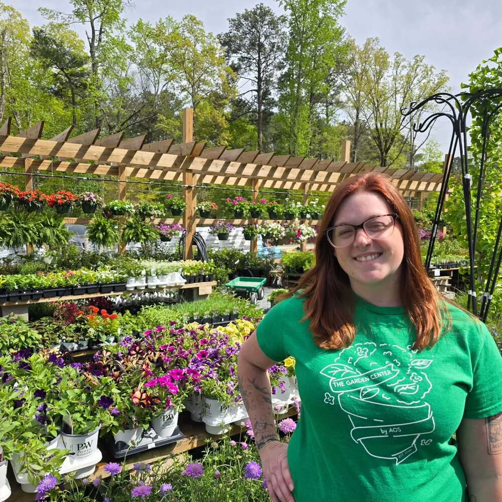 Smiling woman in colorful plant nursery