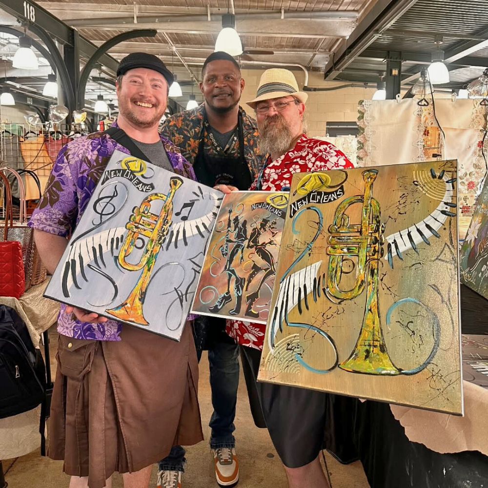New Orleans artist and painter, Larry Desvignes (center) with Jazz-inspired art pieces
