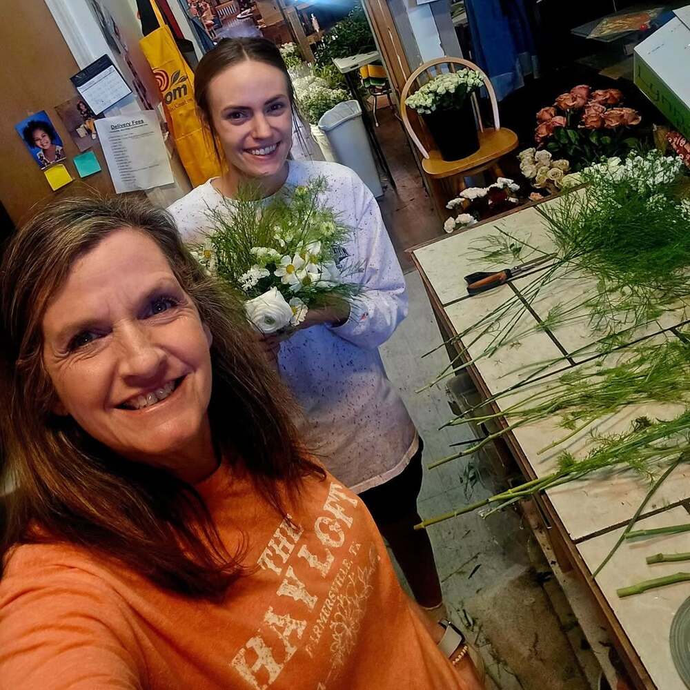 Florists working on wedding bouquets indoors
