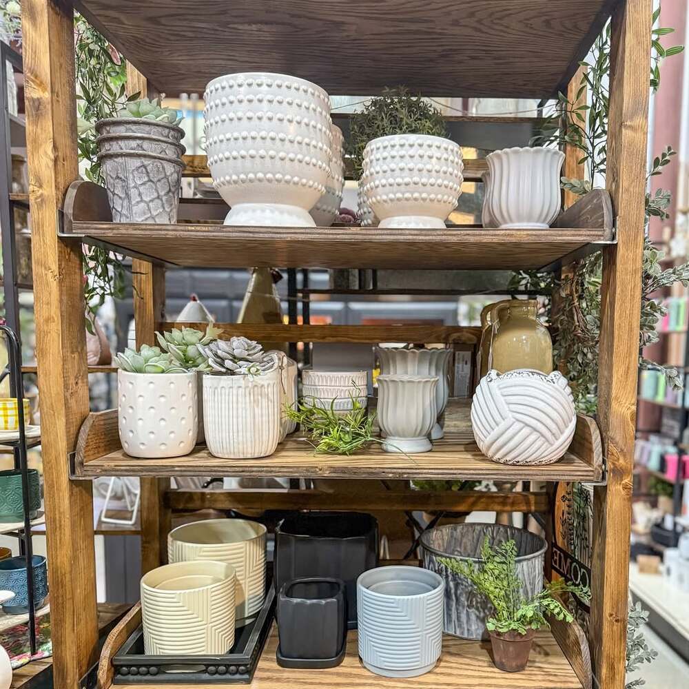 Decorative pots on wooden shelf display Decorative pots on wooden shelf display