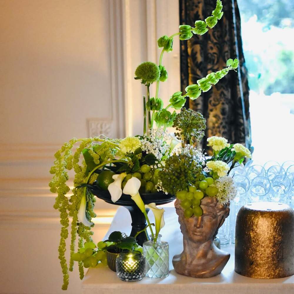 Elaborate green floral arrangement with grapes Elaborate green floral arrangement with grapes