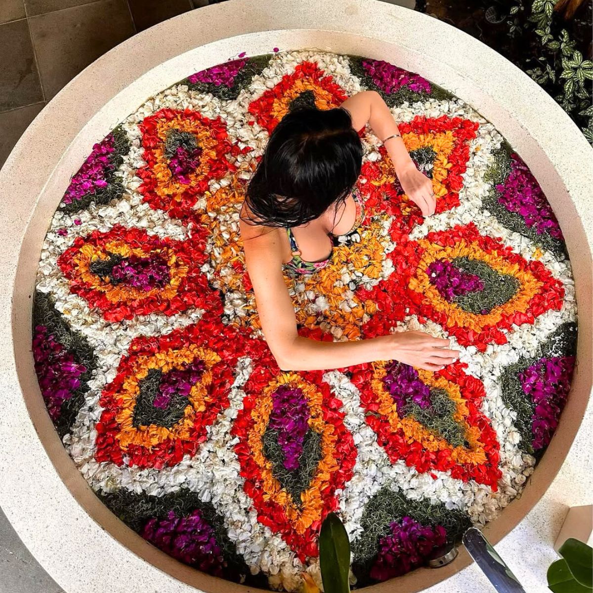 A circular flower bath filled with petals