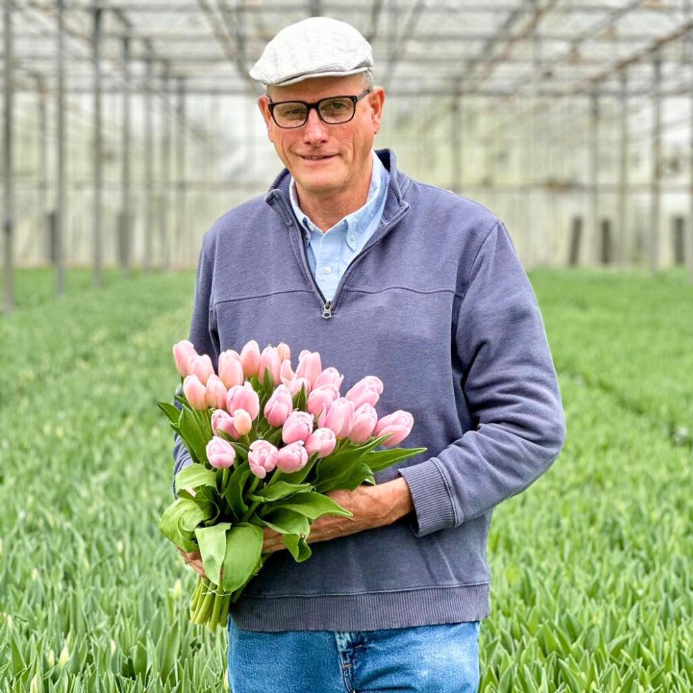 Lane DeVries holding a bunch of pink tulips 10 Questions to Lane DeVries