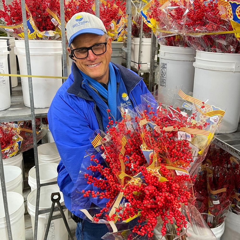 Lane DeVries holding bunches of  Ilex Verticillata 10 Questions to Lane DeVries