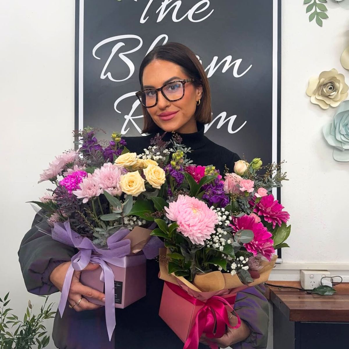 A girl with two get well soon flower arrangements A girl with two get well soon flower arrangements