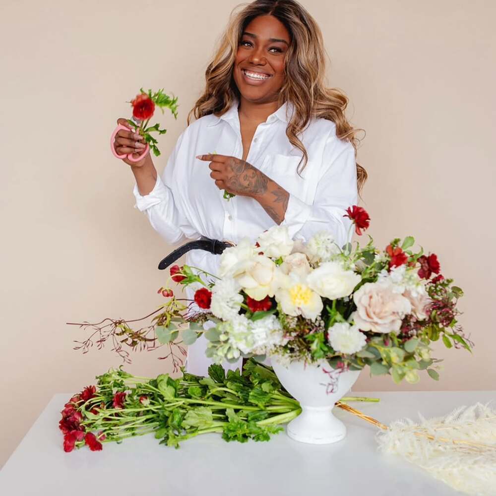 Smiling florist creating a bouquet