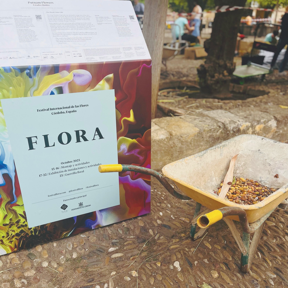 FLORA festival sign beside wheelbarrow FLORA festival sign beside wheelbarrow