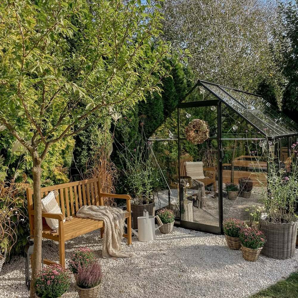 Garden greenhouse and cozy wooden bench