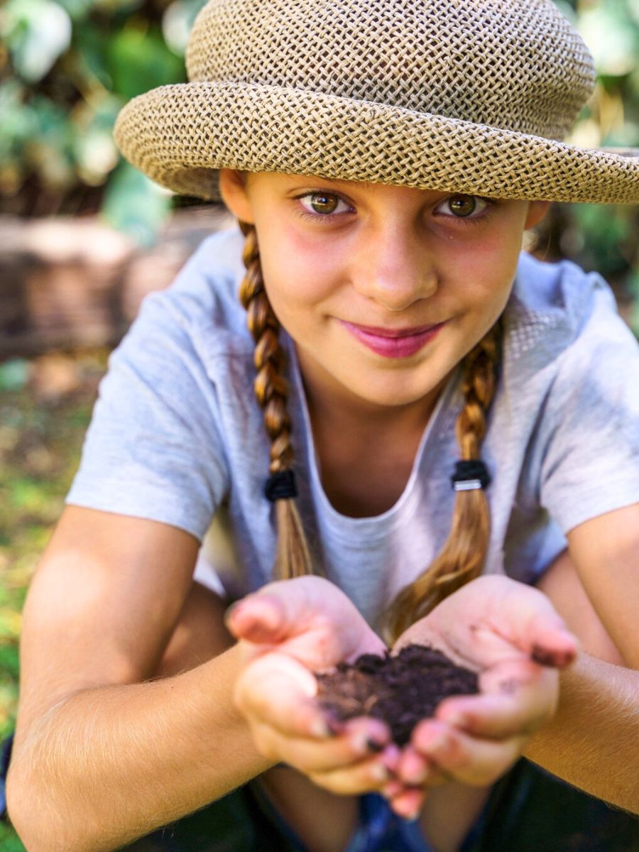 Girl holding soil in her hands