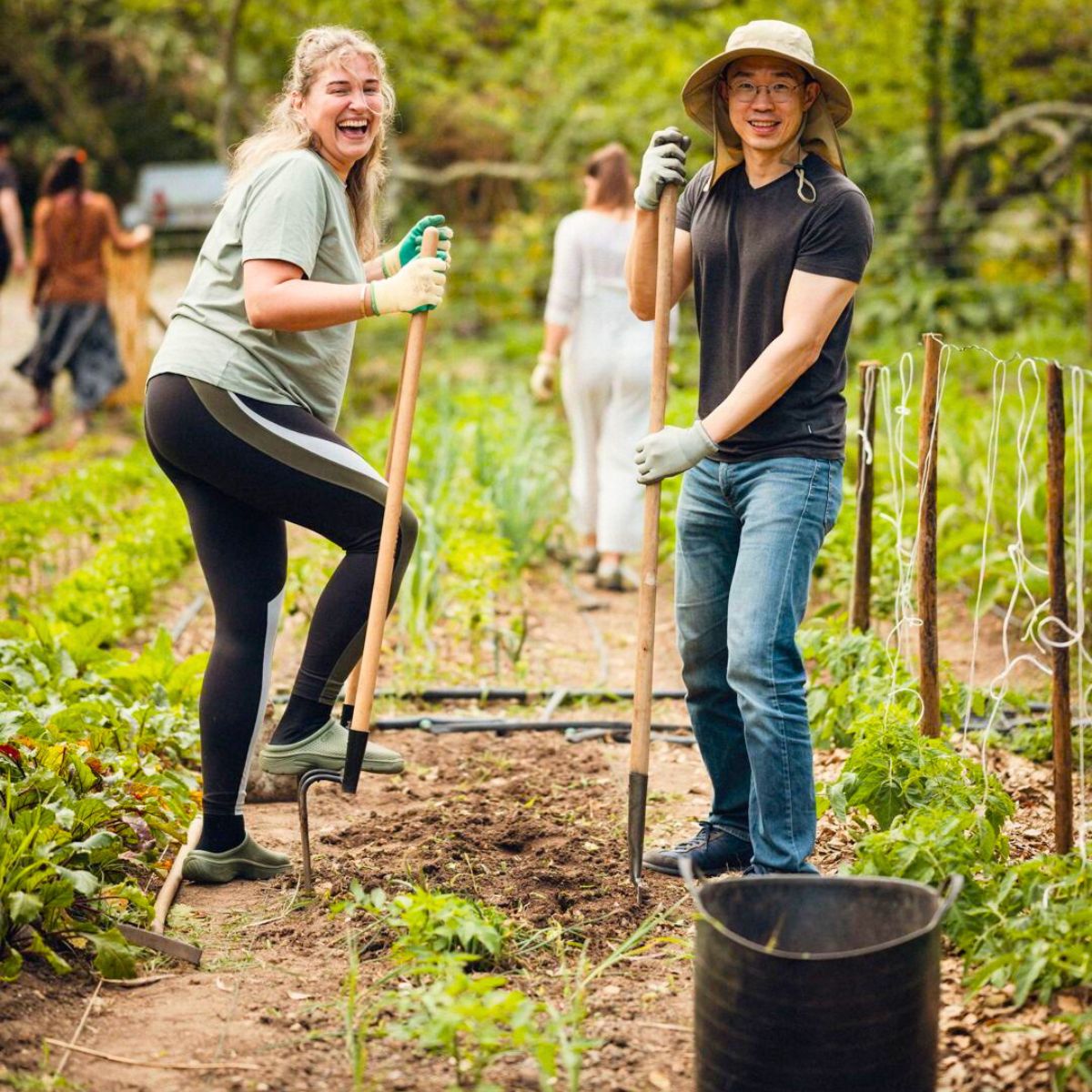 Two people taking care of the soil