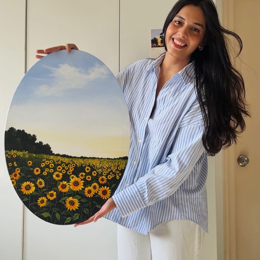 lady with canvas painting in home