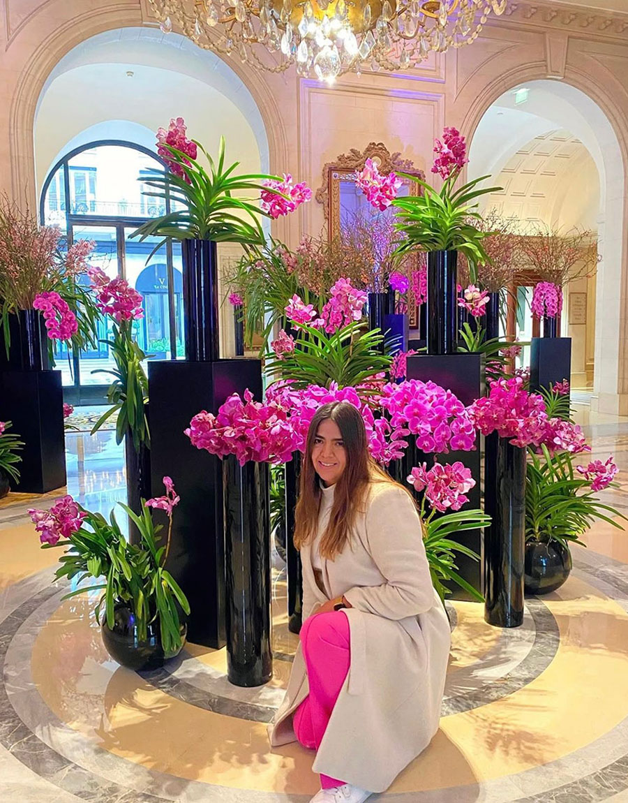 Lu Vargas posing with pink orchid designs