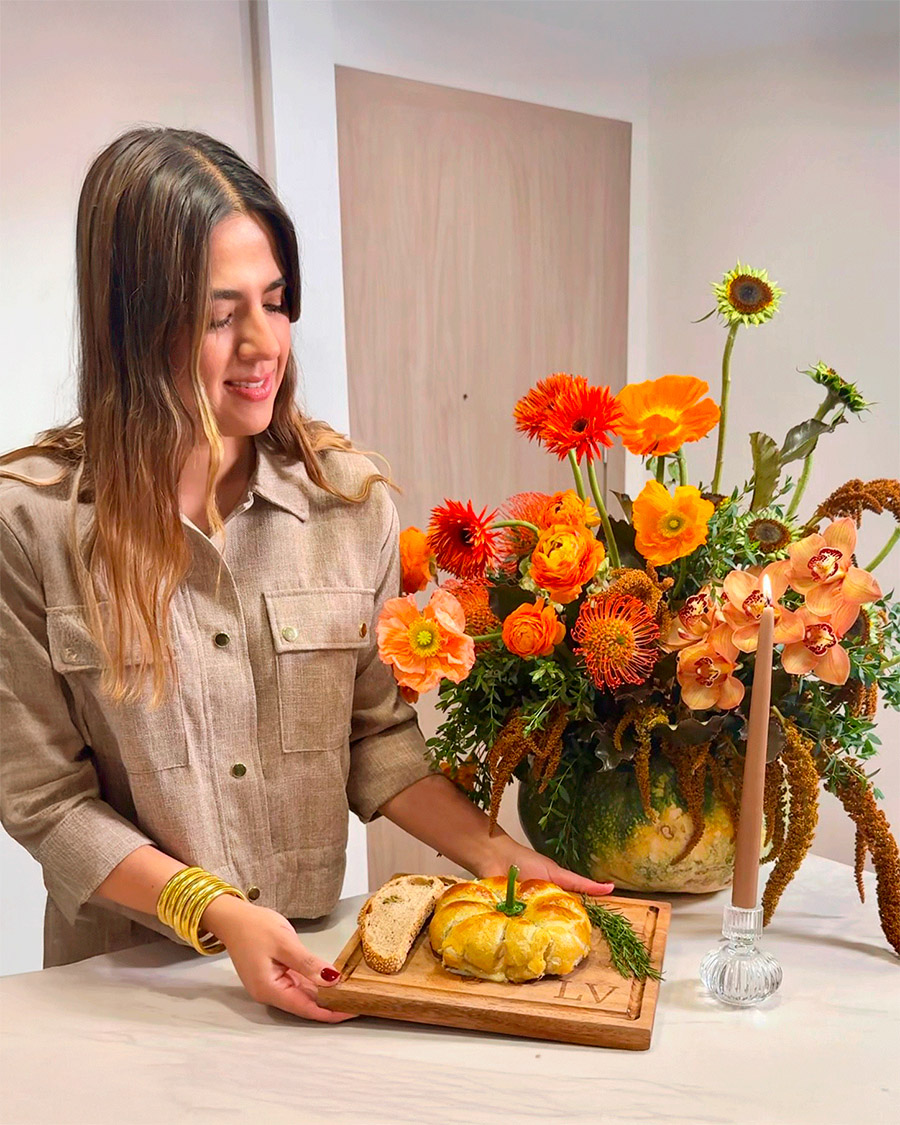 Lu Vargas holding pumpkin bread with orange flower design Lu Vargas holding pumpkin bread with orange flower design