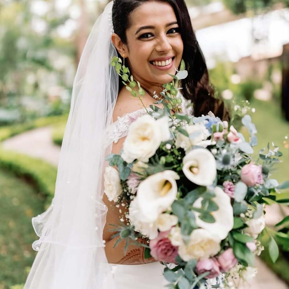 Bride holding large white floral bouquet