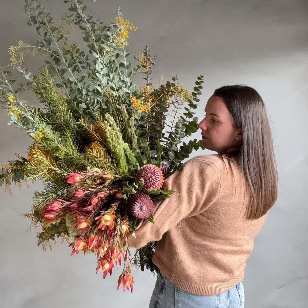  Florist with Large Native Australian Arrangement