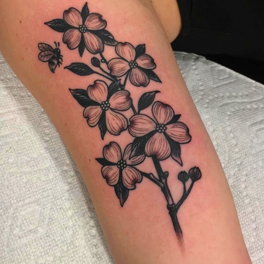 black ink tattoo of dogwood flower on arm