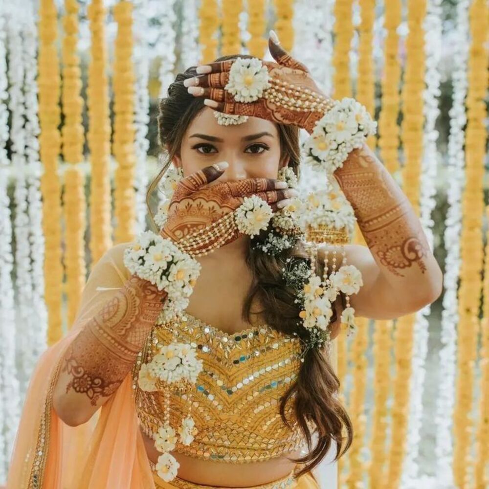 Indian bride with floral jewelry and henna