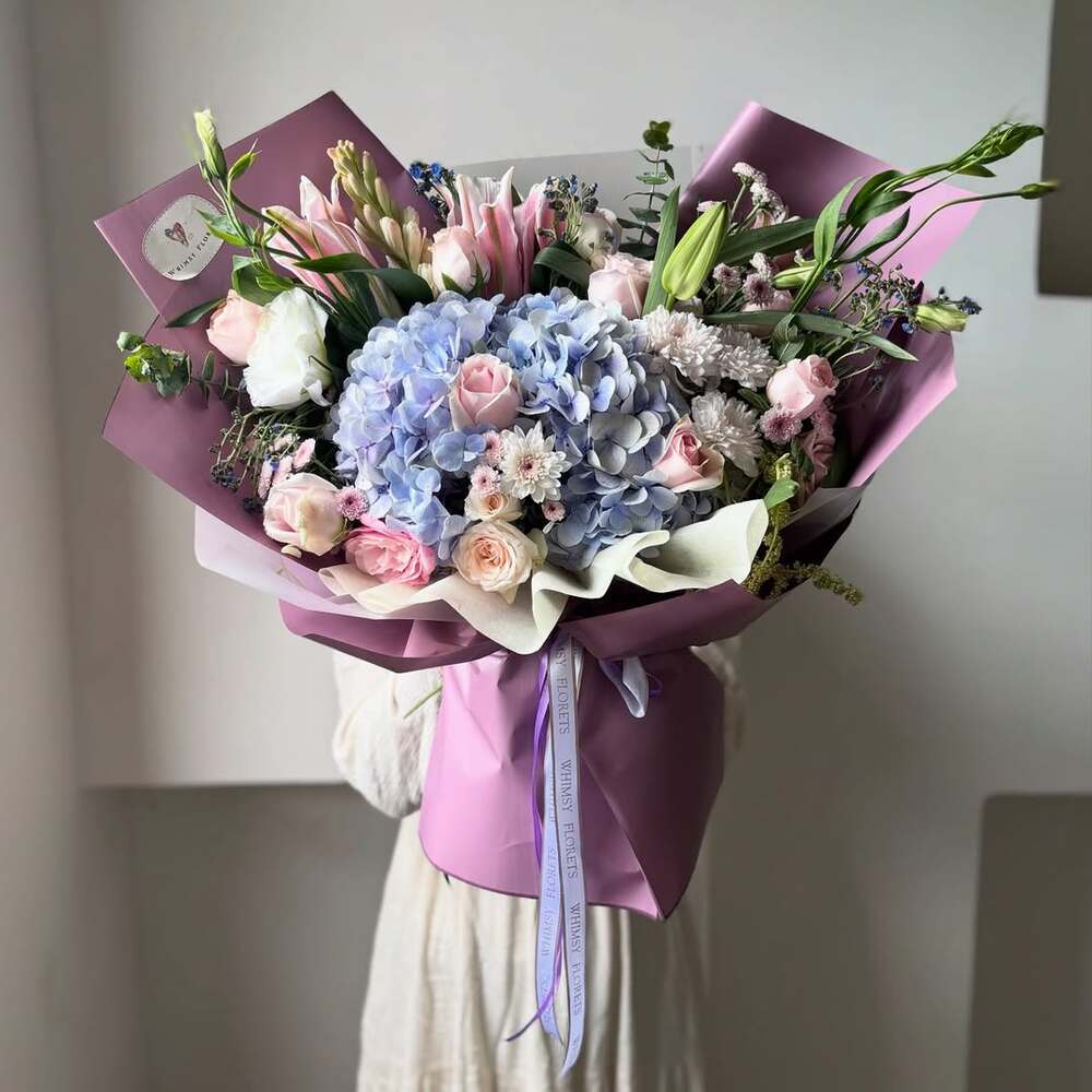 Lush bouquet featuring blue hydrangea